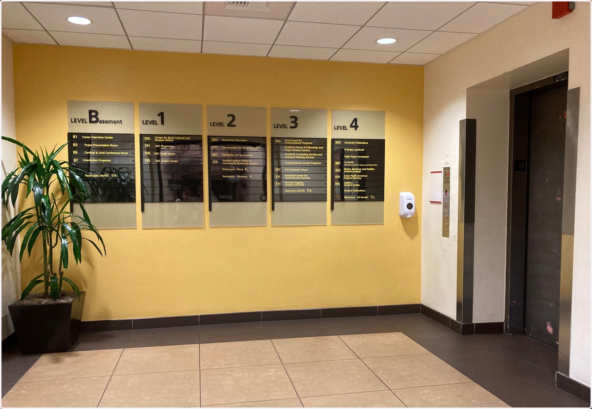 Enter the building, go straight ahead, the elevator room is in the middle of the hallway on your left