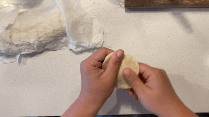 Pinch out the edges of one piece of the dough and roll out into a circle (or imperfect circle) ⚪️