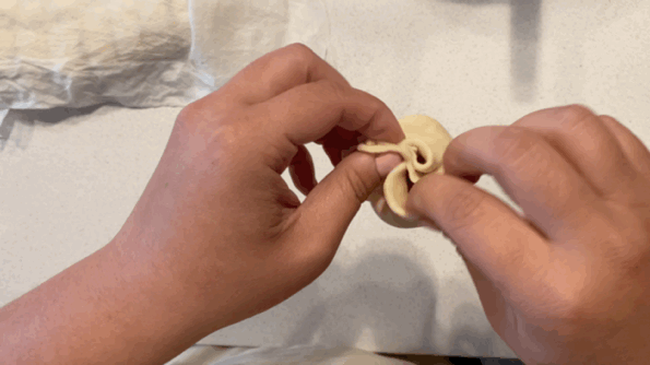 Twist the top of the dough to close it off. Make sure they're completely sealed! 💌