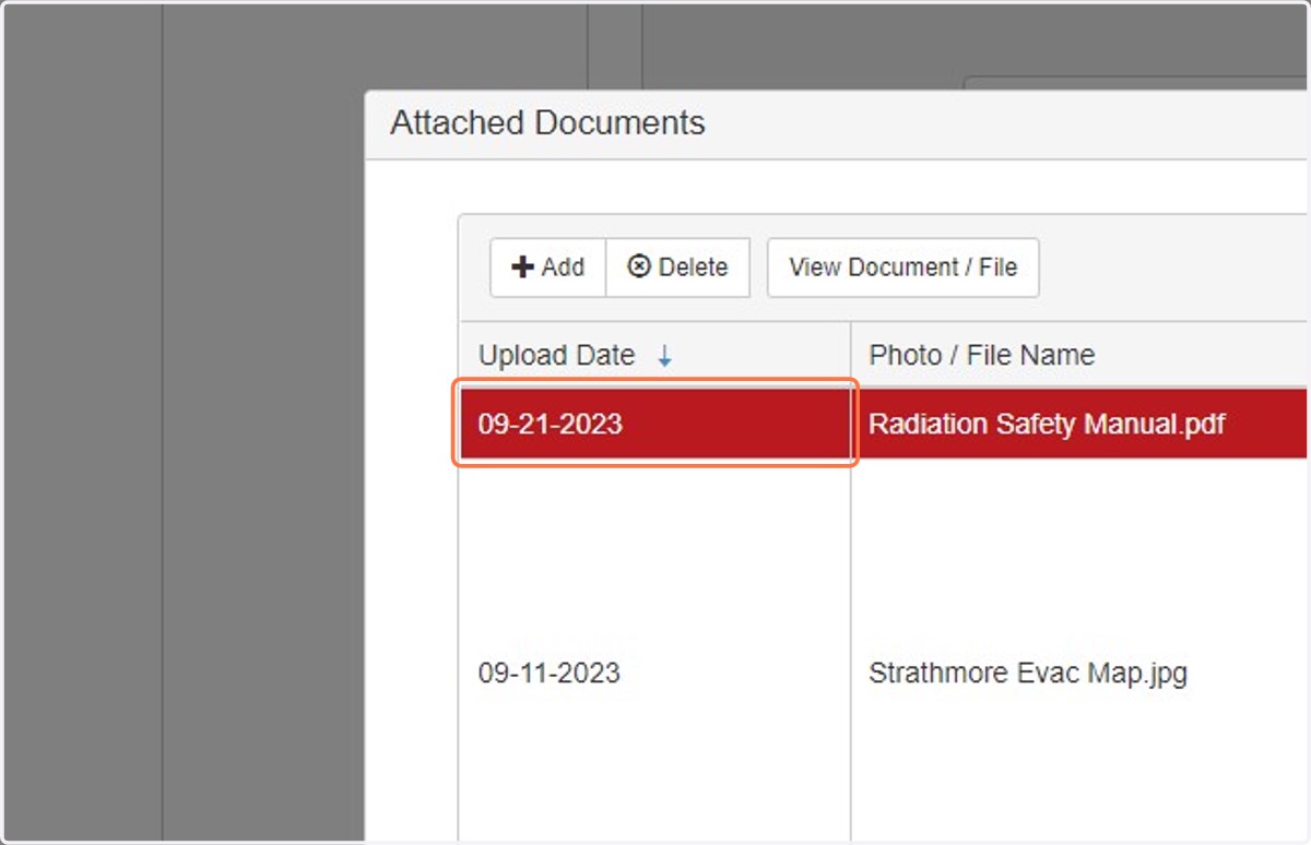 The new photo/file should now appear in the table of attached documents.